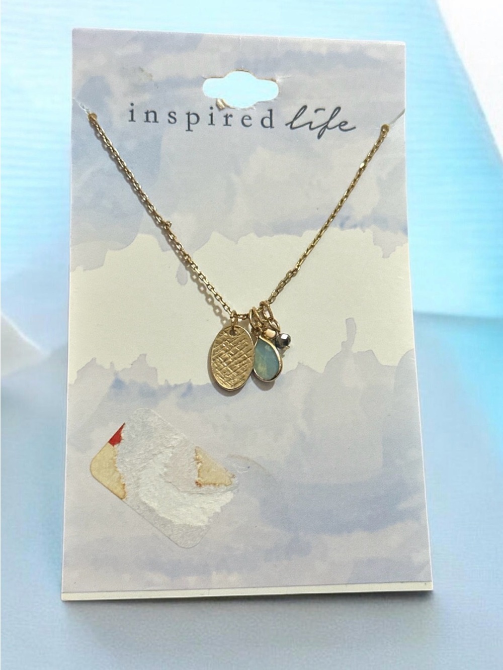 Inspired Life Gold Pendant Necklace with Aqua Teardrop Charm
2025
